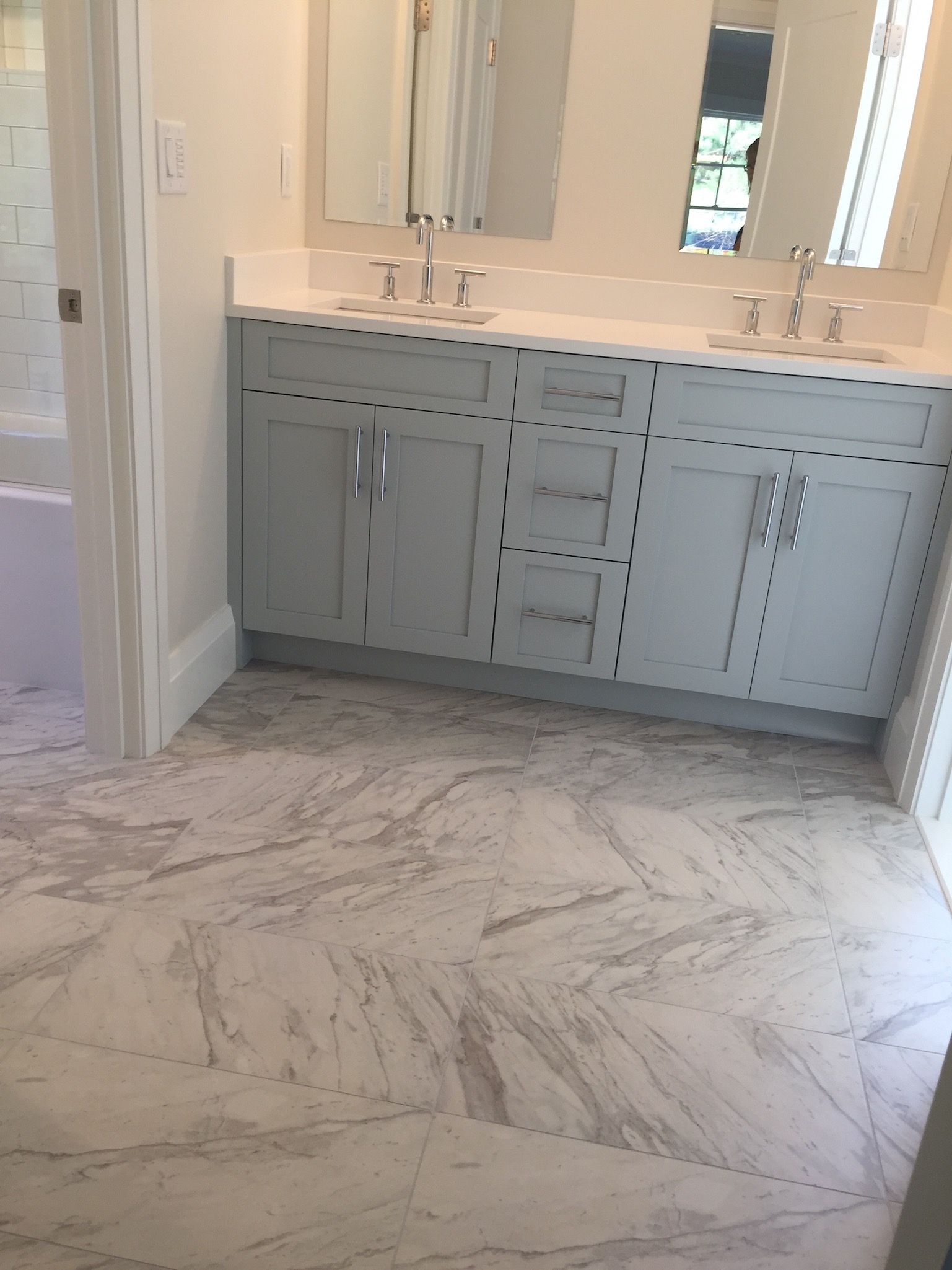 A bathroom with two sinks and a mirror