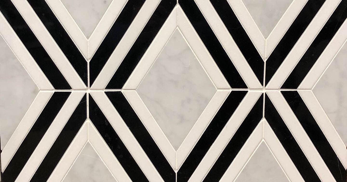 A black and white tile with a geometric pattern on it