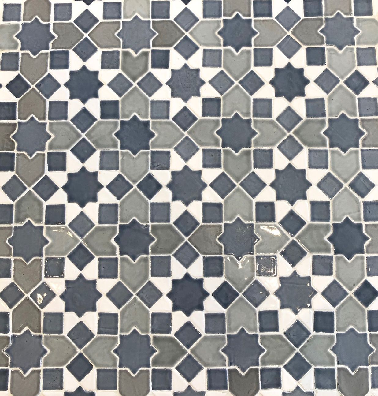 A black and white tile with a geometric pattern