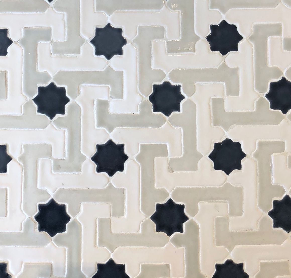 A close up of a tile with a black and white pattern