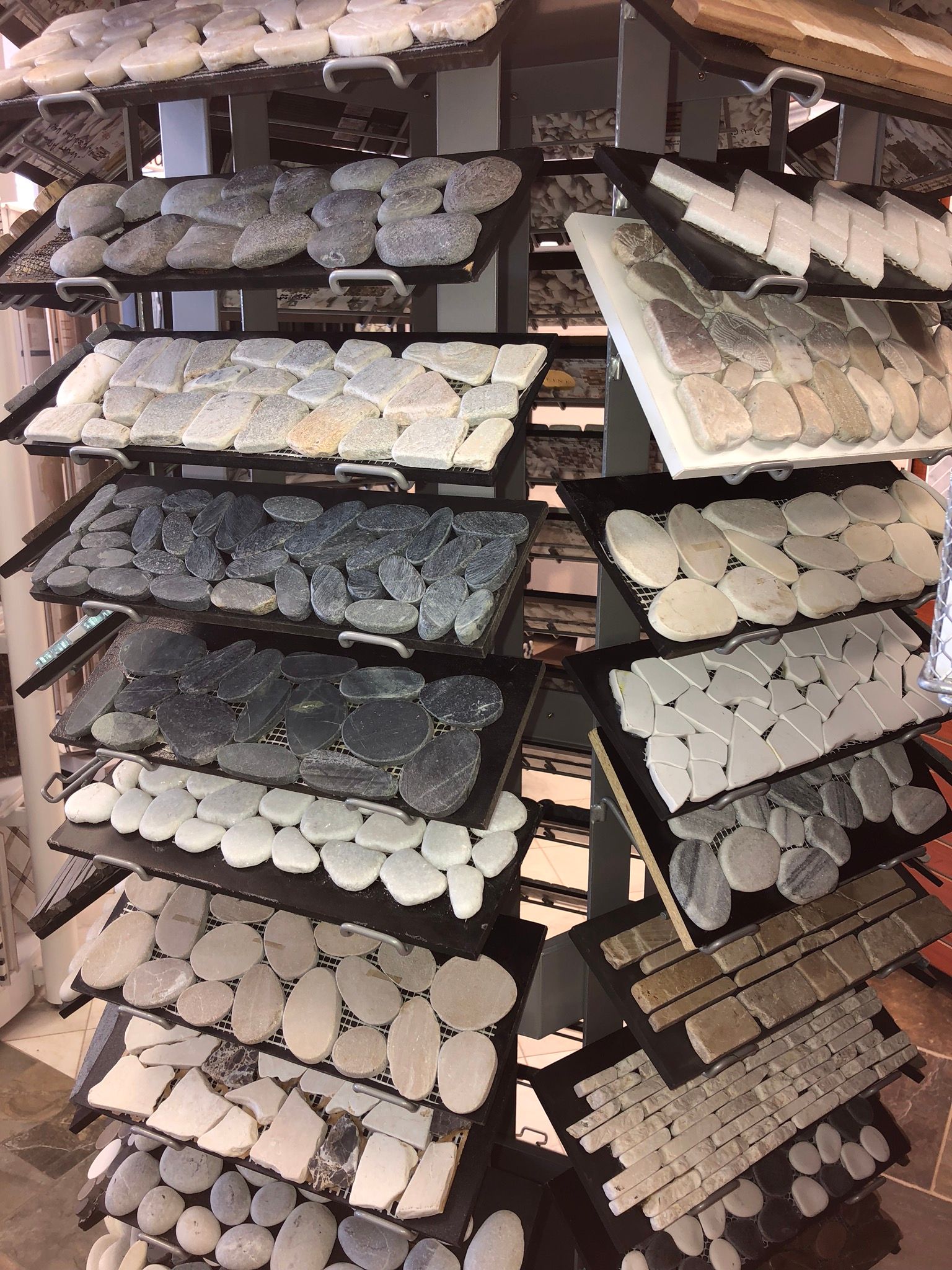 There are many different types of rocks on the shelves.