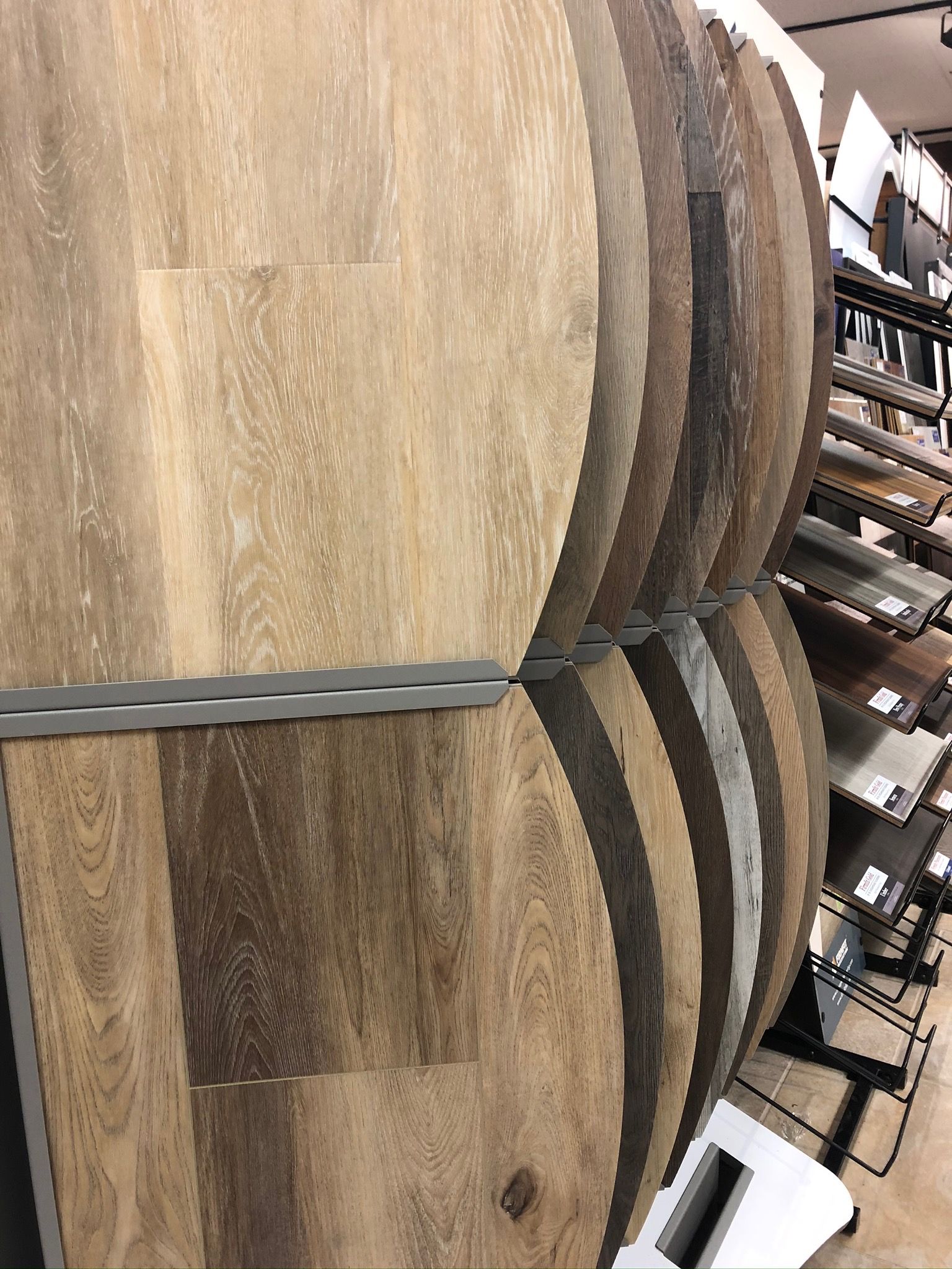 A bunch of wooden barrels are stacked on top of each other in a store.