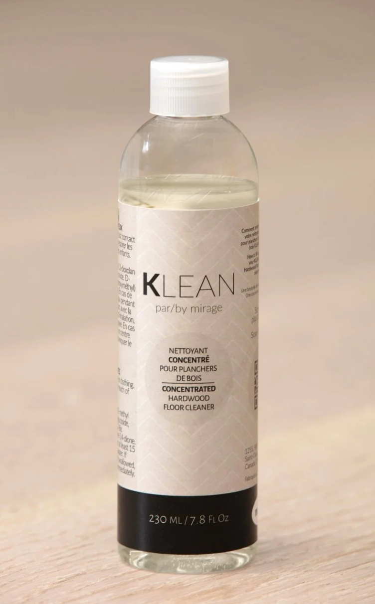 A bottle of klean is sitting on a wooden table.