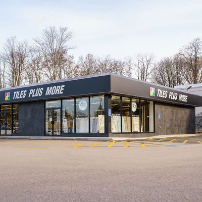 A tiles plus more store with a lot of windows