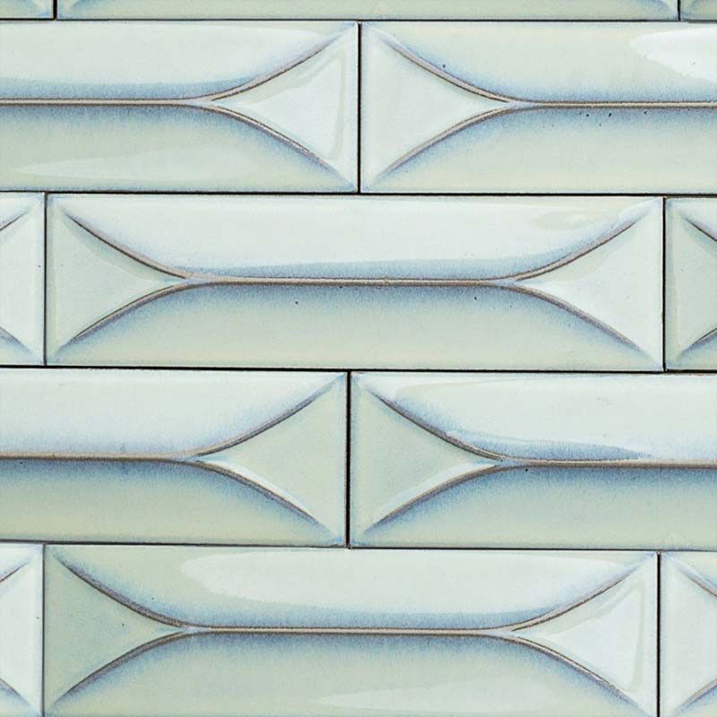A close up of a white tile wall with a diamond pattern.