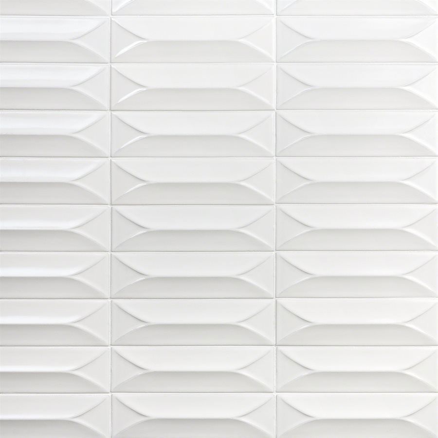 A close up of a white tile wall with a geometric pattern.