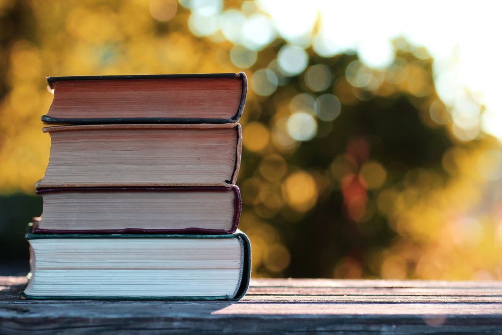 A stack of books tied together with string