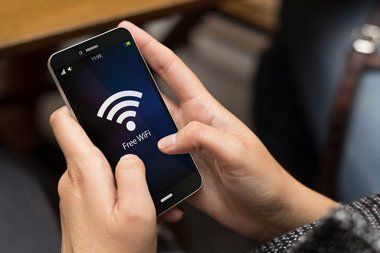 Girl Using Phone with Free Wi-fi on the Screen — Electrician in Newtown, QLD