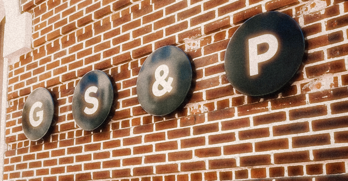 A brick wall with gs & p written on it