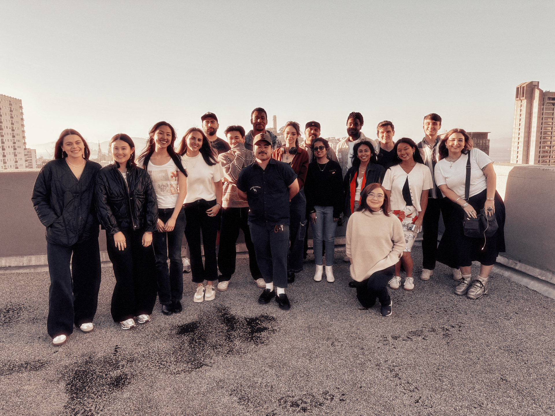 A group of people are posing for a picture on a rooftop.