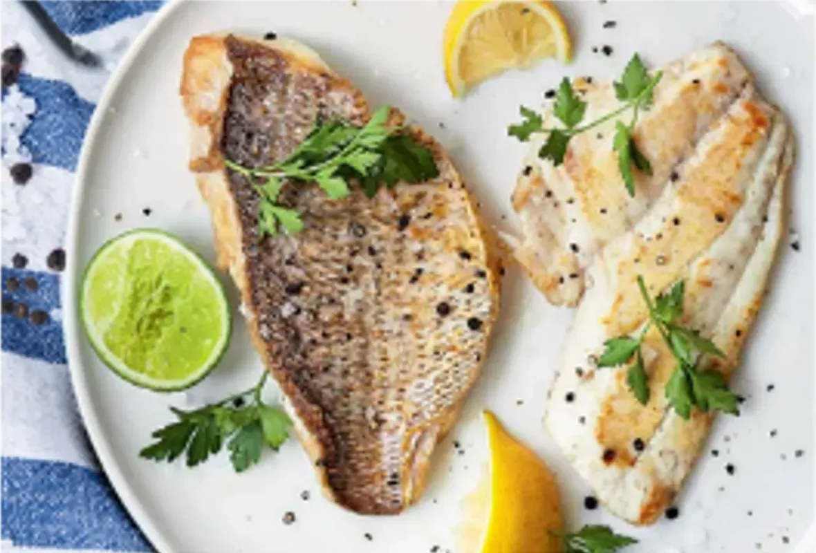 Pan-seared Fish Fillets With Lemon, Lime, and Parsley on a White Plate — Pt Cartwright Seafoods in Warana, QLD
