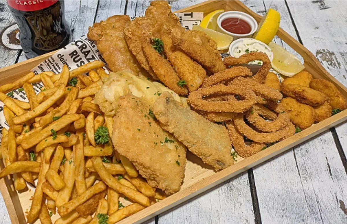 Fried Seafood Platter With Fries, Onion Rings, and Lemon Wedges — Pt Cartwright Seafoods in Warana, QLD