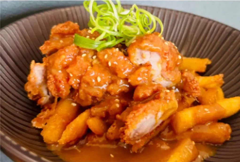 Chicken Dish With Sauce, Carrots, Sesame Seeds, and Scallions in a Brown Bowl — Pt Cartwright Seafoods in Warana, QLD