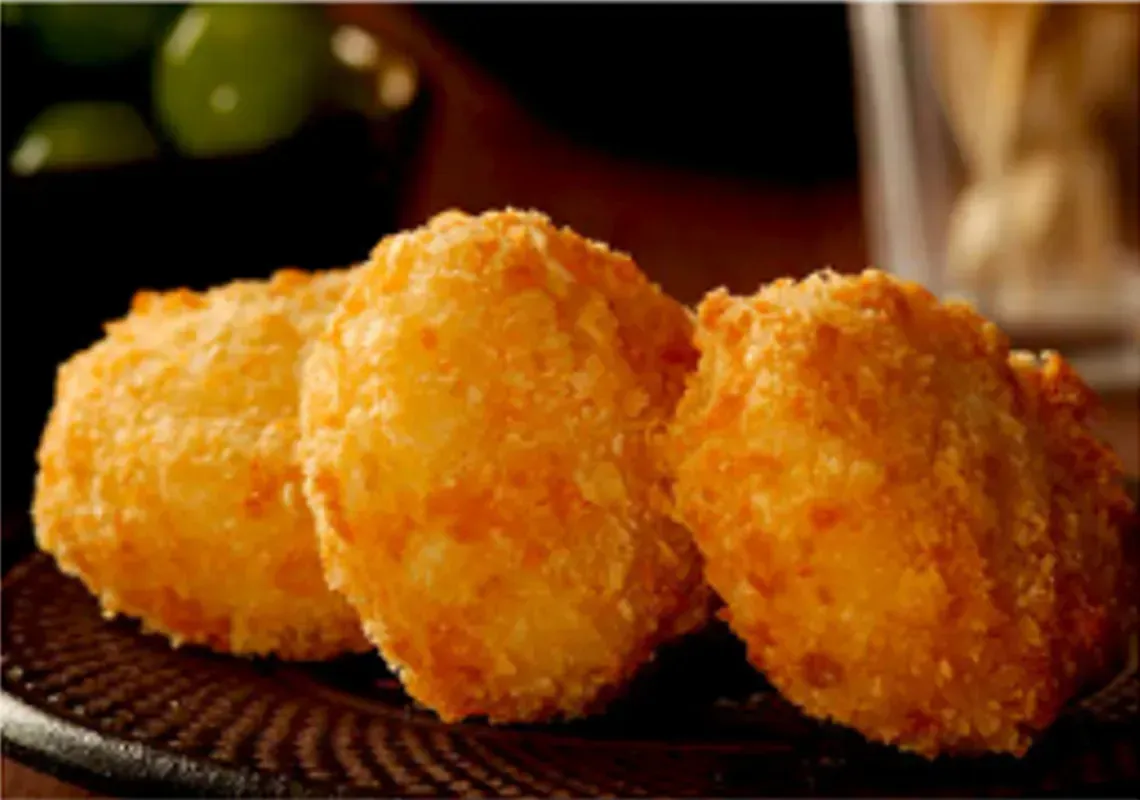 Golden-brown, Fried Potato Puffs on a Dark Plate — Pt Cartwright Seafoods in Warana, QLD