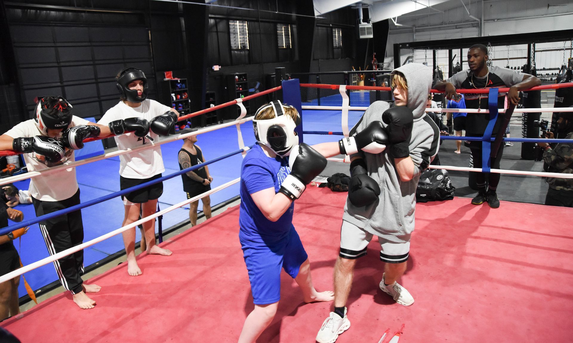 A group of people are boxing in a boxing ring.