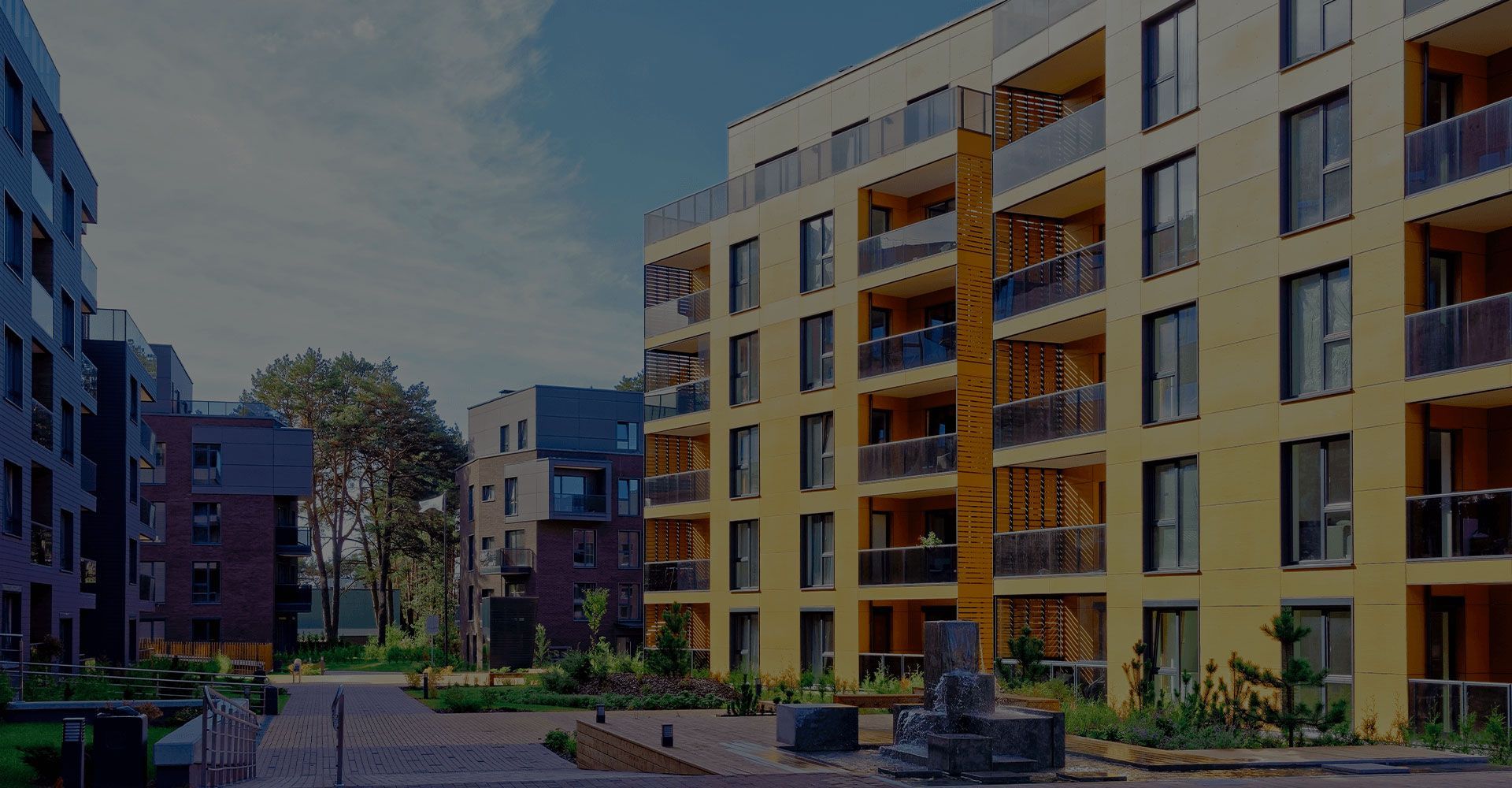 A row of apartment buildings with balconies in a residential area.