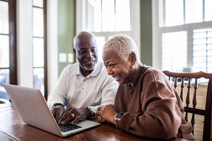 Senior Couple Using Laptop At Home — Chiefland, FL — Smith Asset Management Company Senior Couple Using Laptop At Home — Chiefland, FL — Smith Asset Management Company