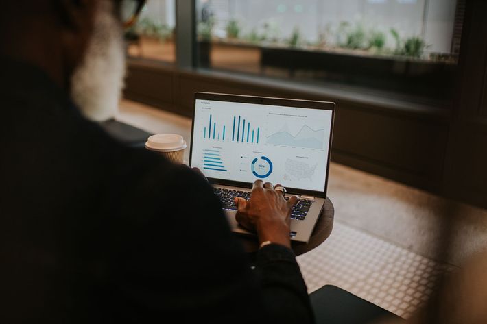 Man Uses A Laptop And Looks At Financial Figures — Chiefland, FL — Smith Asset Management Company Man Uses A Laptop And Looks At Financial Figures — Chiefland, FL — Smith Asset Management Company
