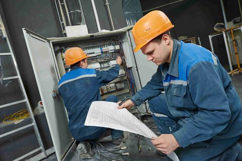 Electricians checking power box