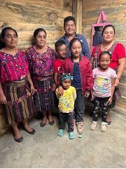 A group of people standing next to each other in a room.