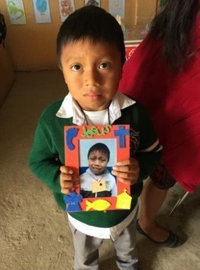 Addison showing his VBS craft