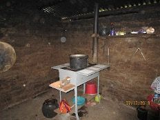 A kitchen with a pot on a stove and a table.