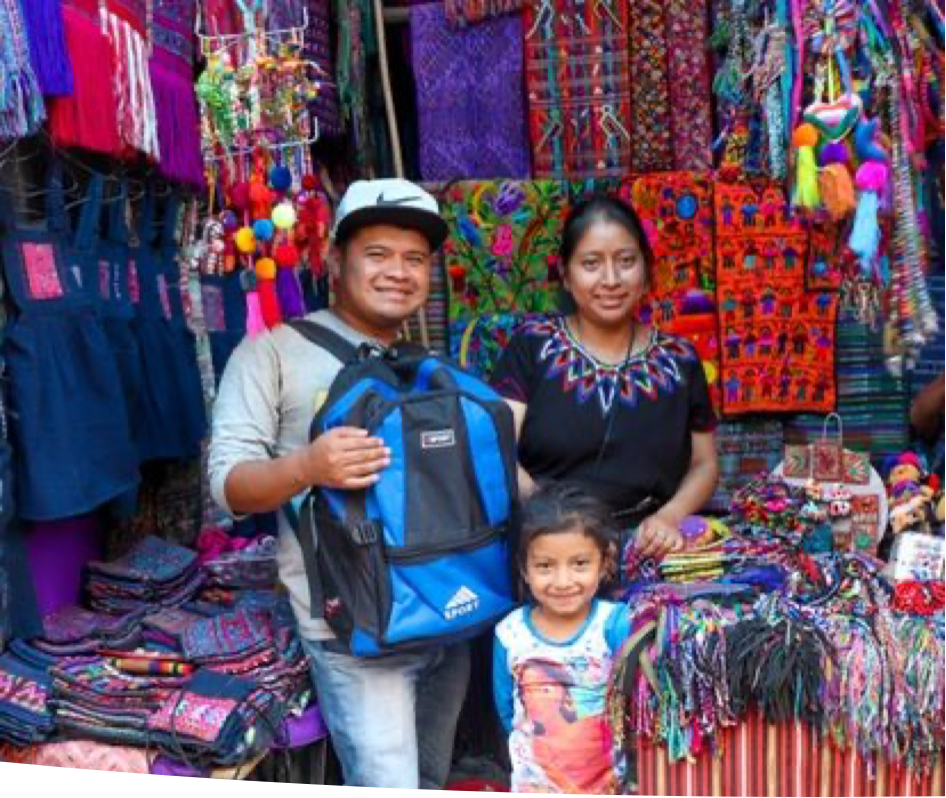 Contact Daily Grace A man holding a blue backpack stands next to a woman and a little girl