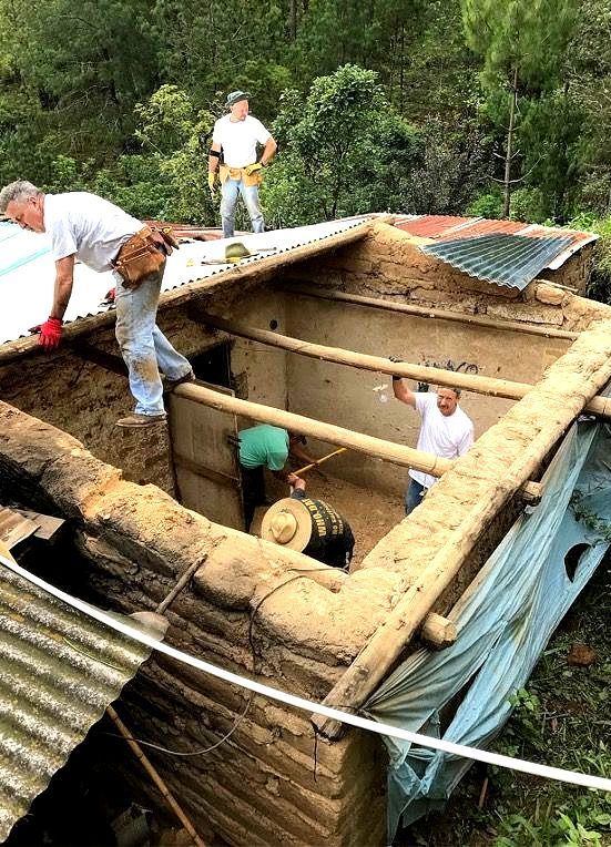 A group of men are working on the roof of a home that needed repairs in Guatemala