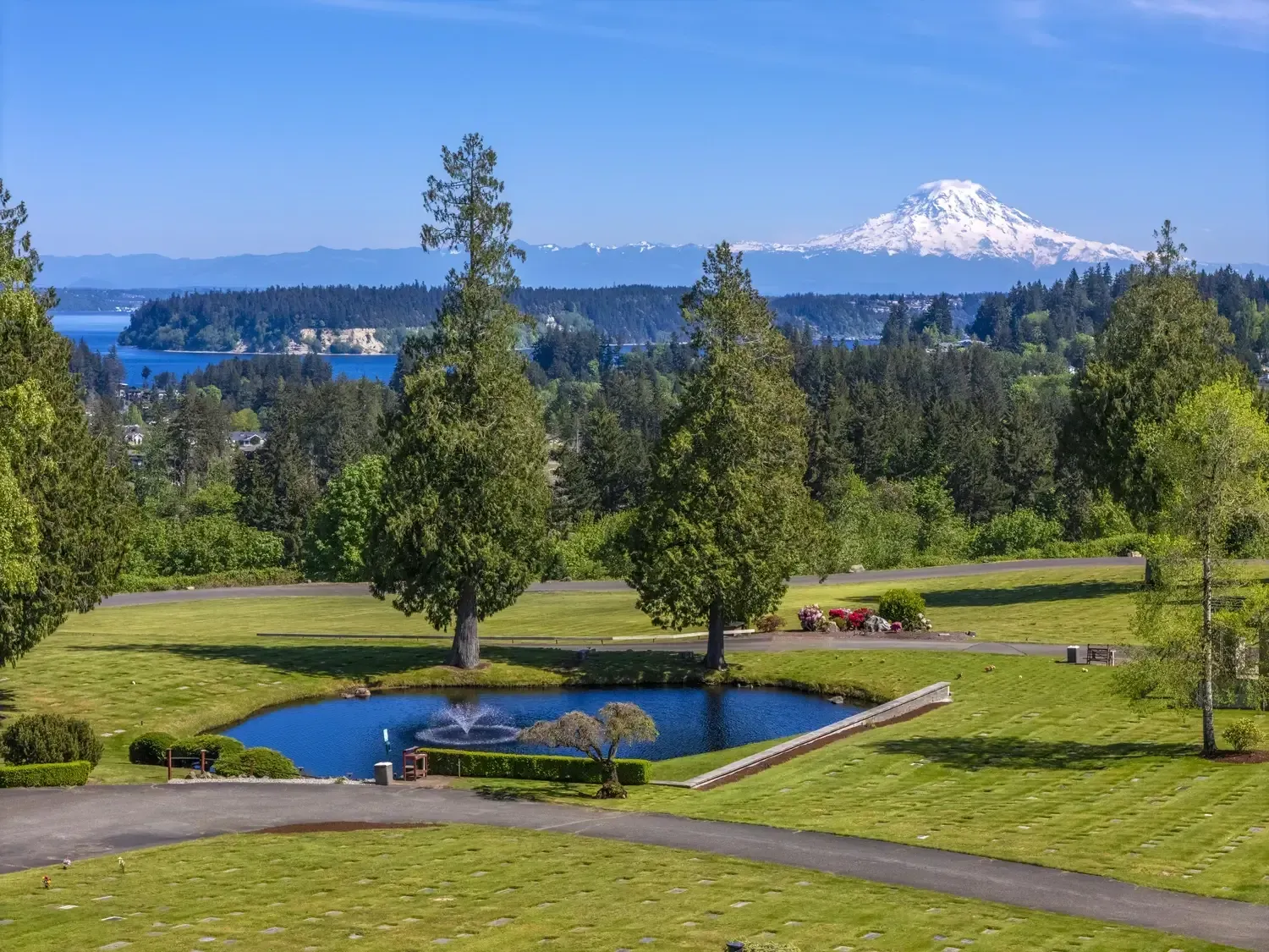Memorial garden with trees, walkways, and open green spaces