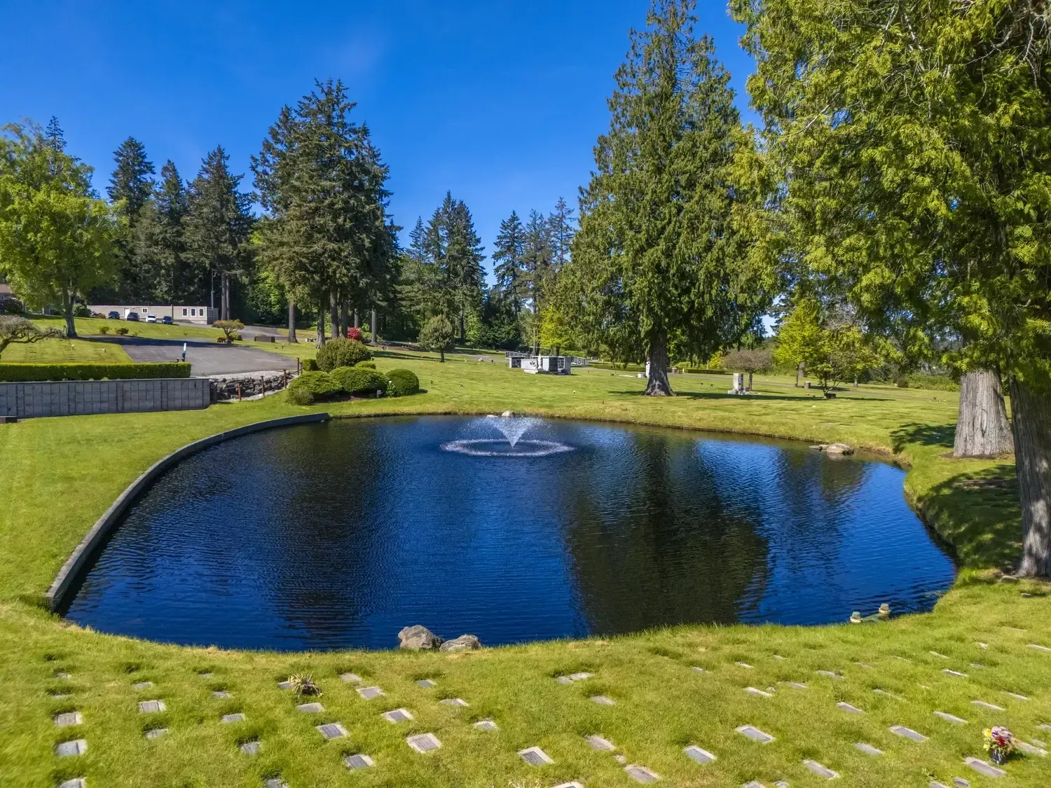 Open memorial lawn with landscaped pathways and trees
