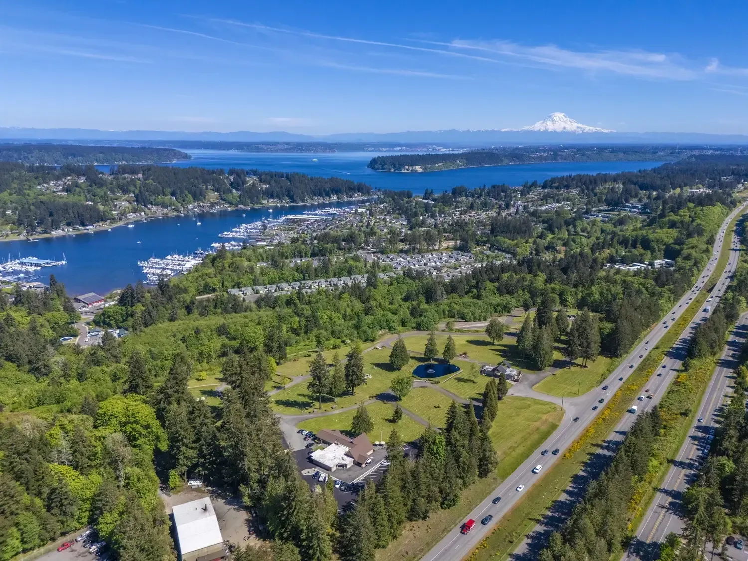 Aerial view of memorial property with scenic landscaping