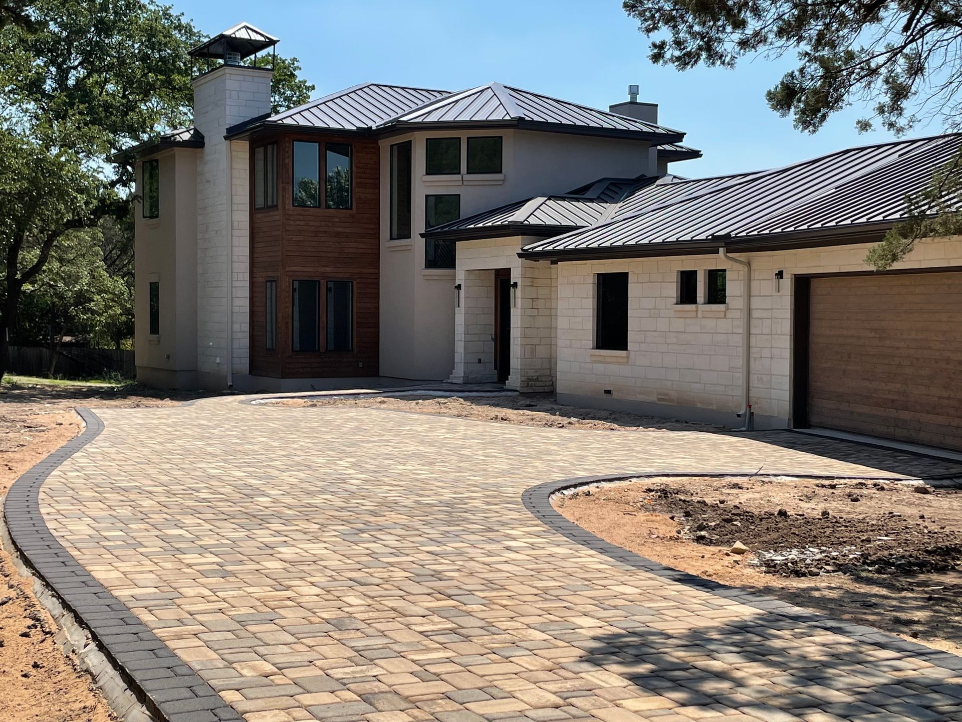 A modern house with a stone and wood facade features.