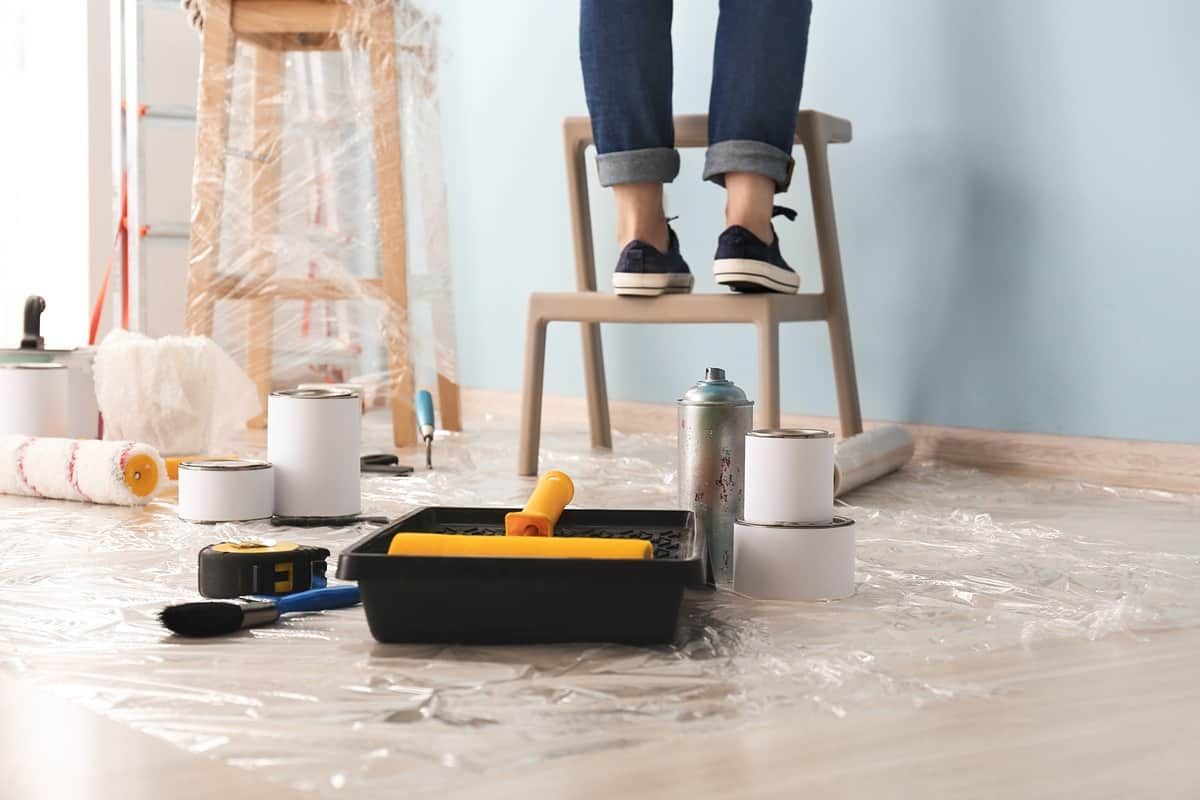 Open can of a paint with paintbrush covering can