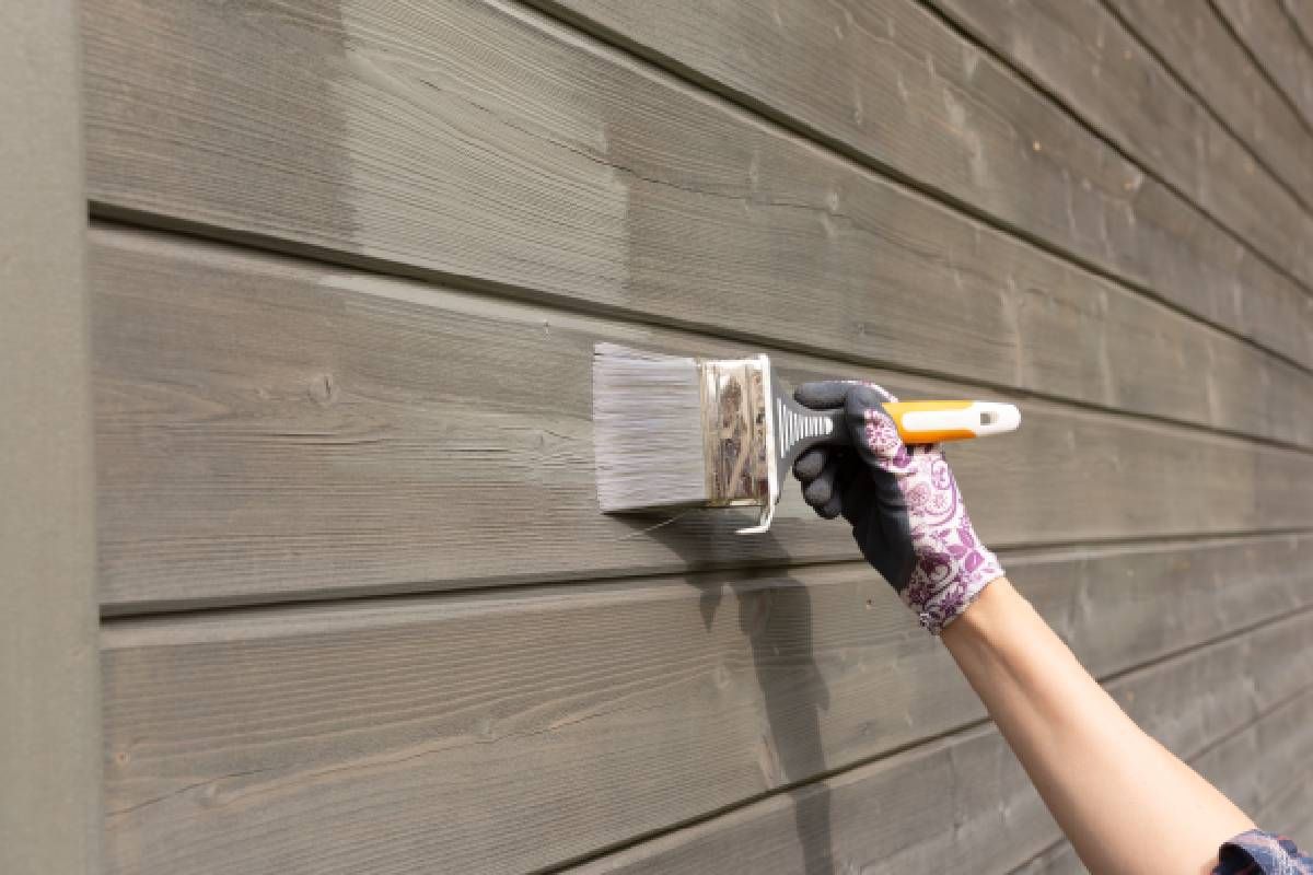 Someone painting the wooden exterior of their house near Lexington, Kentucky (KY)