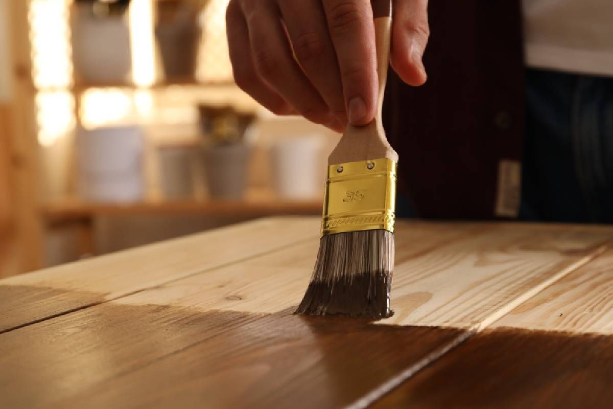 Someone applying wood stain to wood near Lexington, Kentucky (KY)