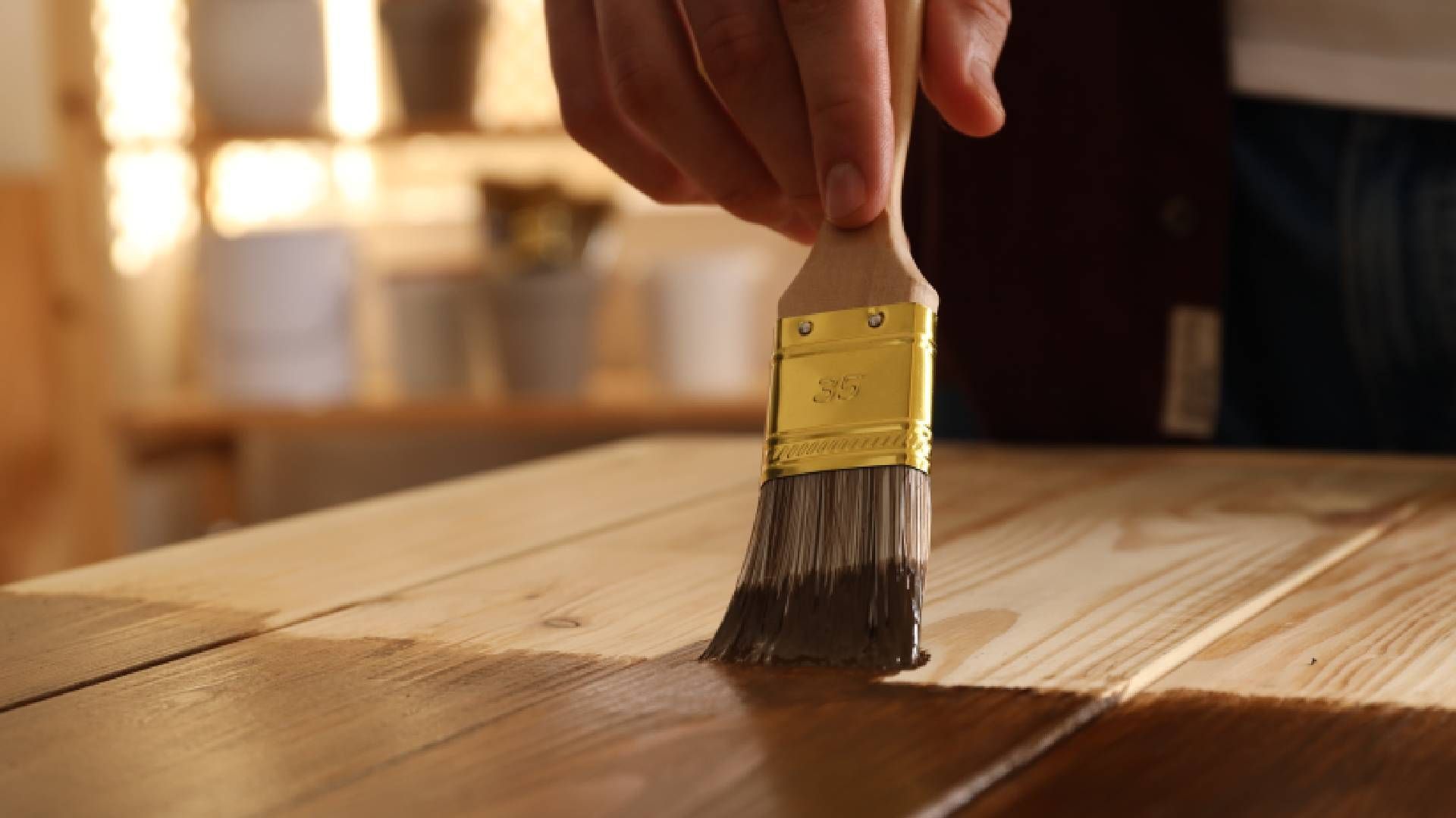 Someone applying wood stain to wood near Lexington, Kentucky (KY)