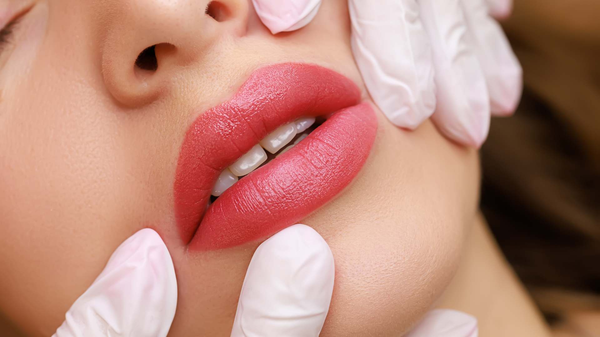 A close up of a woman 's lips being examined by a doctor.