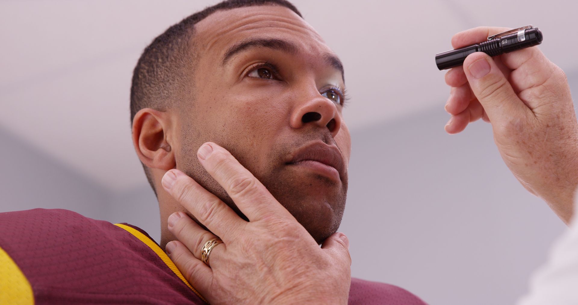 Doctor examining a patient’s eye with an ophthalmoscope
