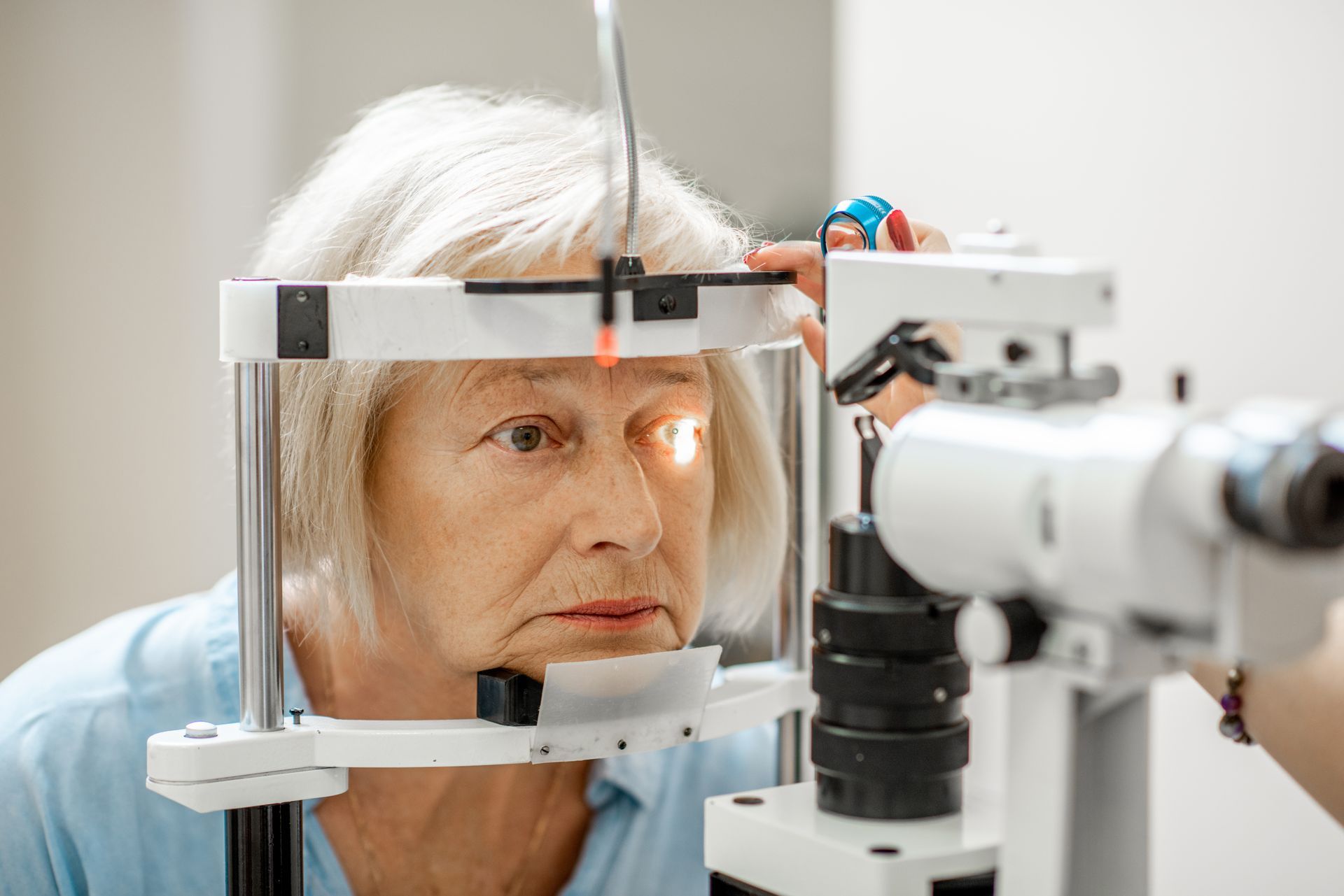 Elderly patient undergoing an eye exam with a slit lamp, focused in a clinic setting Elderly patient undergoing an eye exam with a slit lamp, focused in a practice setting