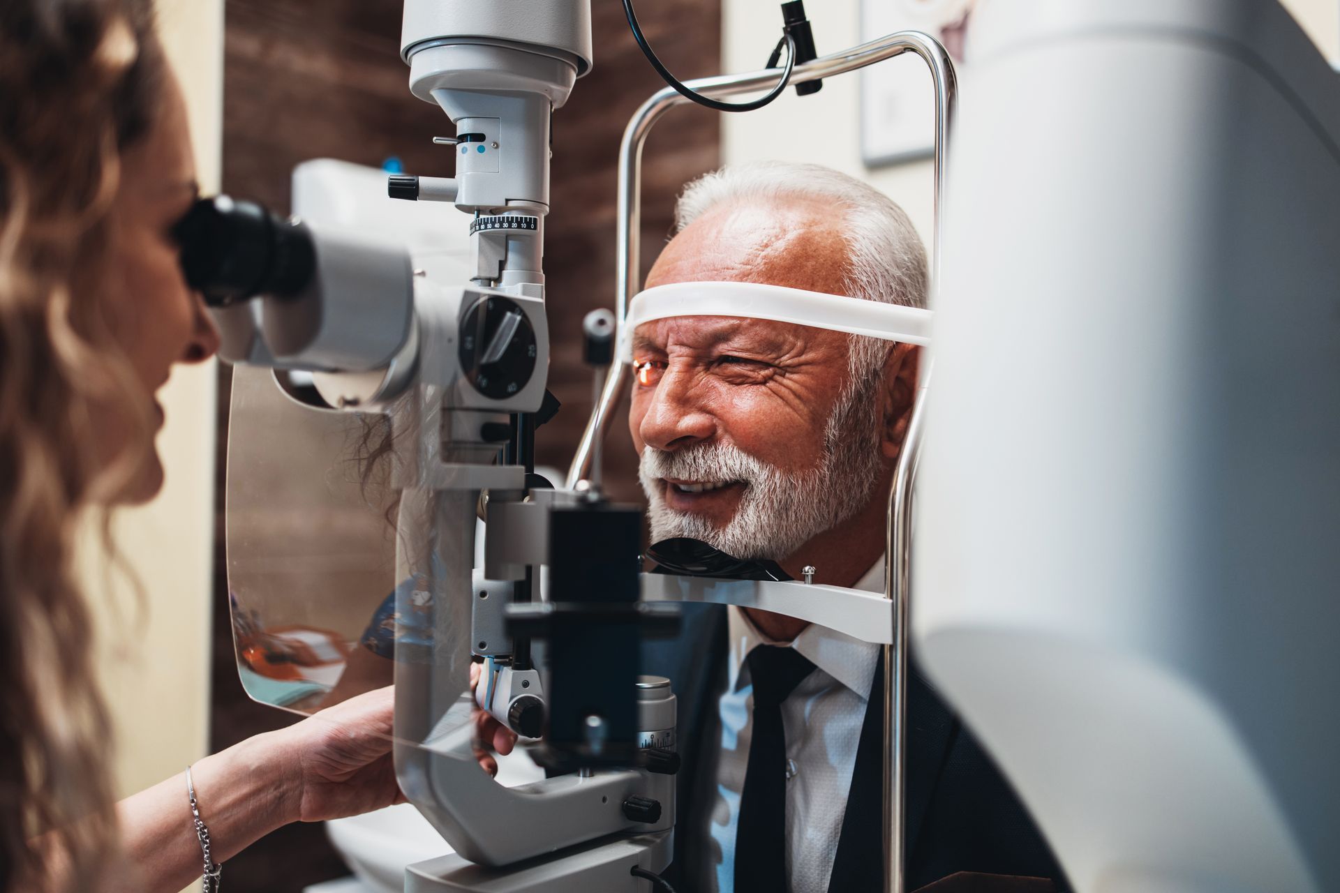 Doctor examining a patient's eye with a slit lamp in a clinic Doctor examining a patient's eye with a slit lamp in a practice