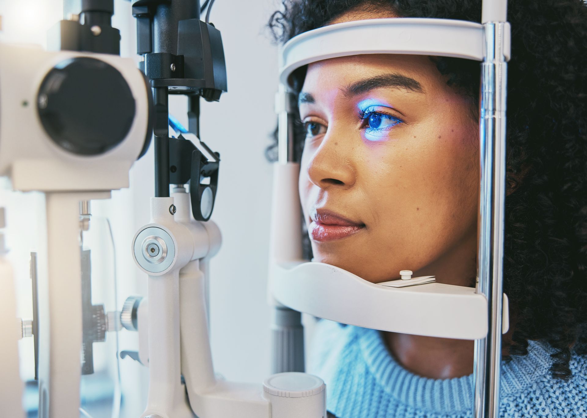 Person undergoing an eye exam with a slit lamp in a practice