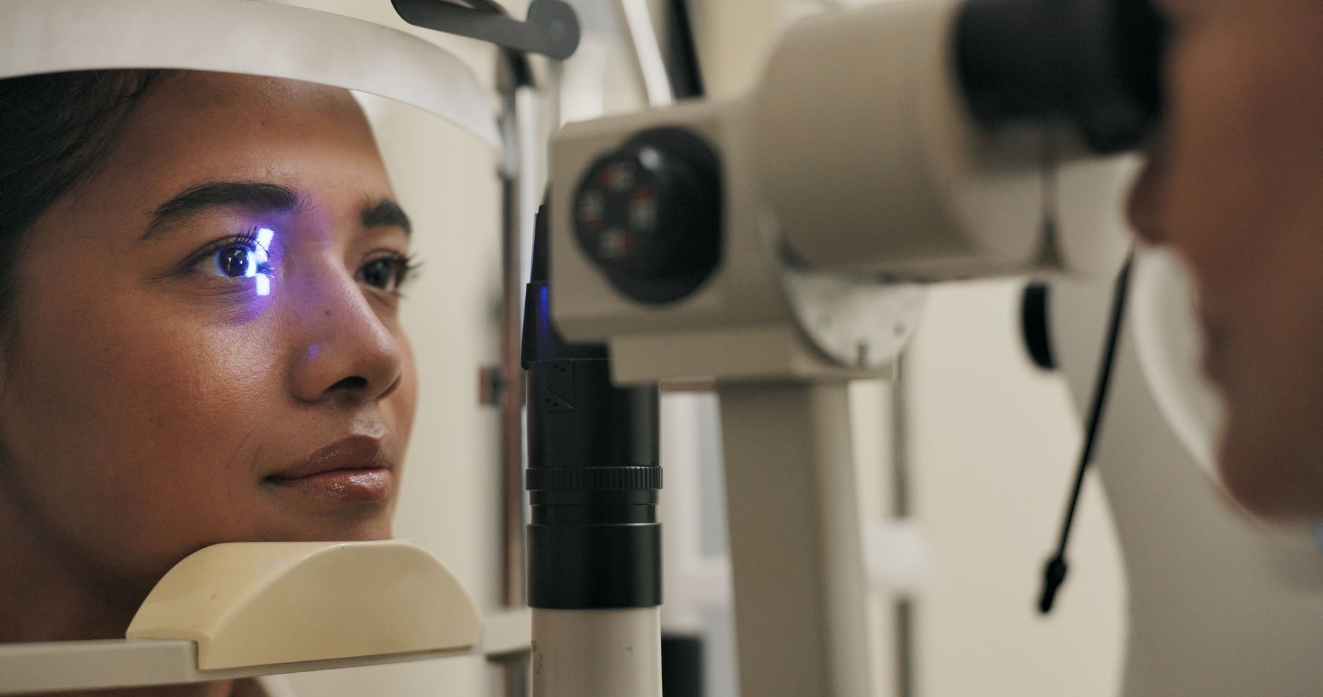 Person having an eye exam with a slit lamp in a practice