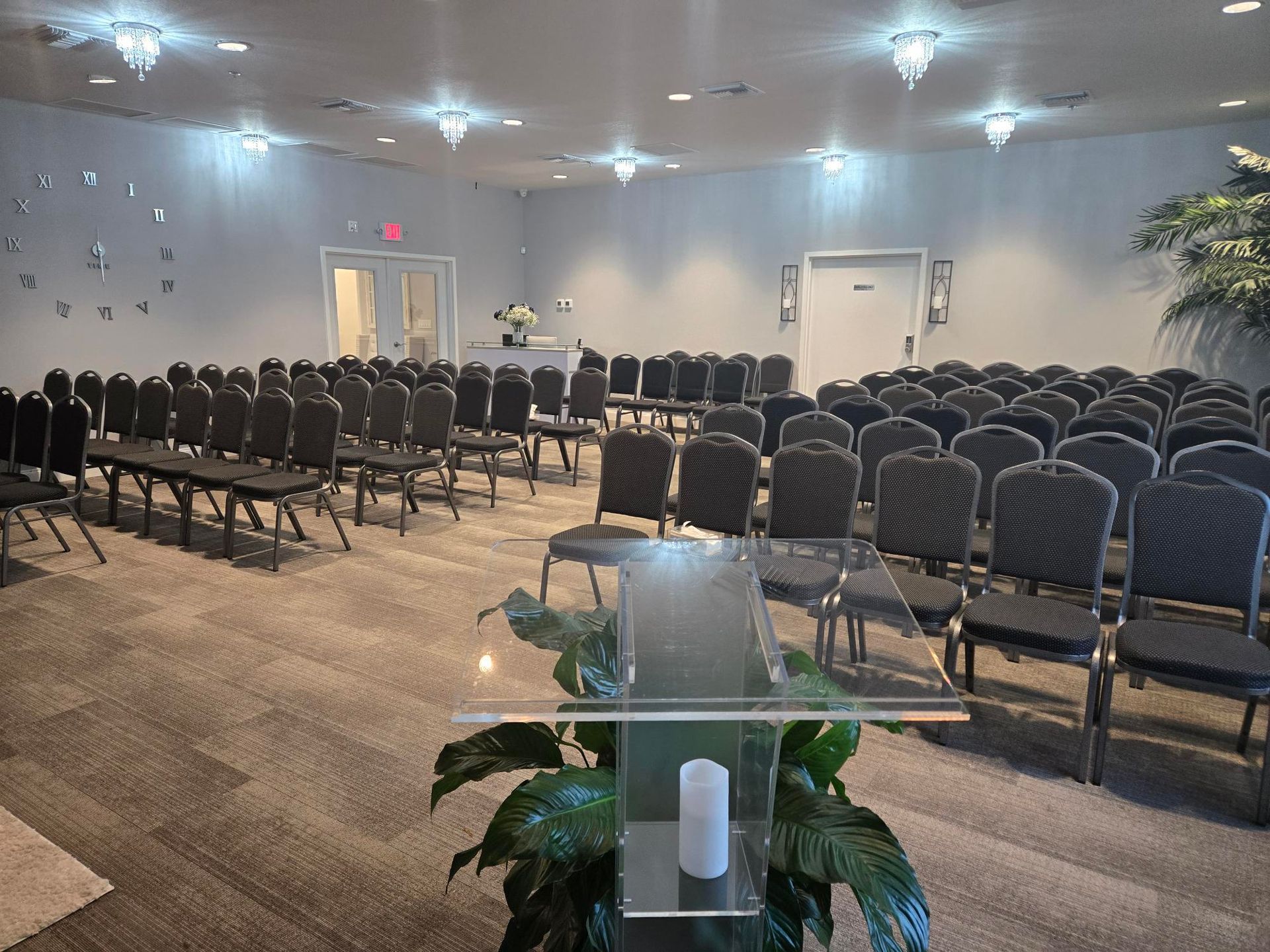 Lobby seating area with black chairs, a flower arrangement, and a Waldon sign on the wall