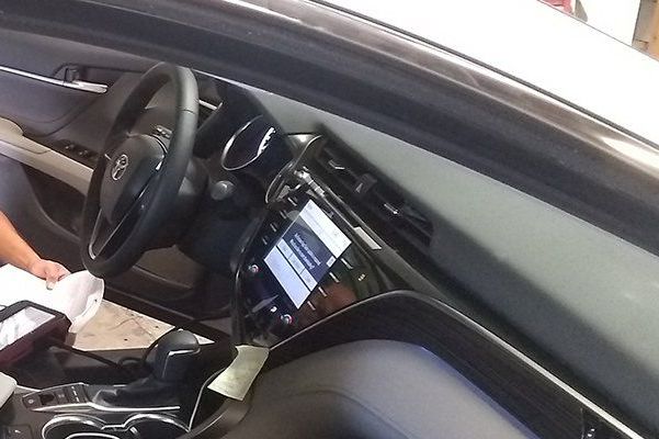 A person is sitting in the driver 's seat of a car A person is sitting in the driver 's seat of a car