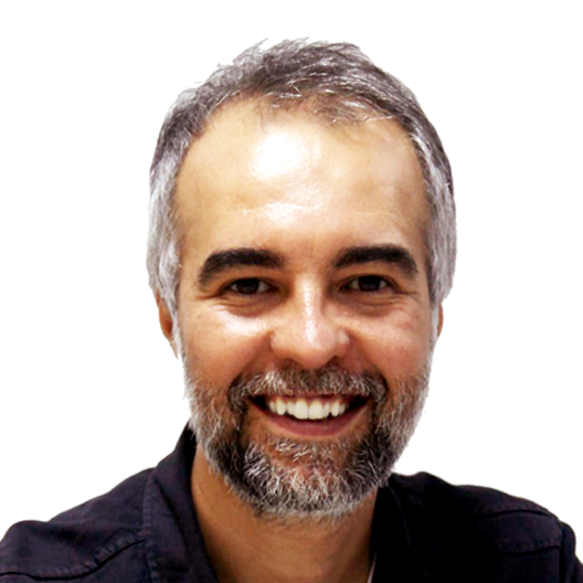 A man with a beard is smiling and wearing a black shirt