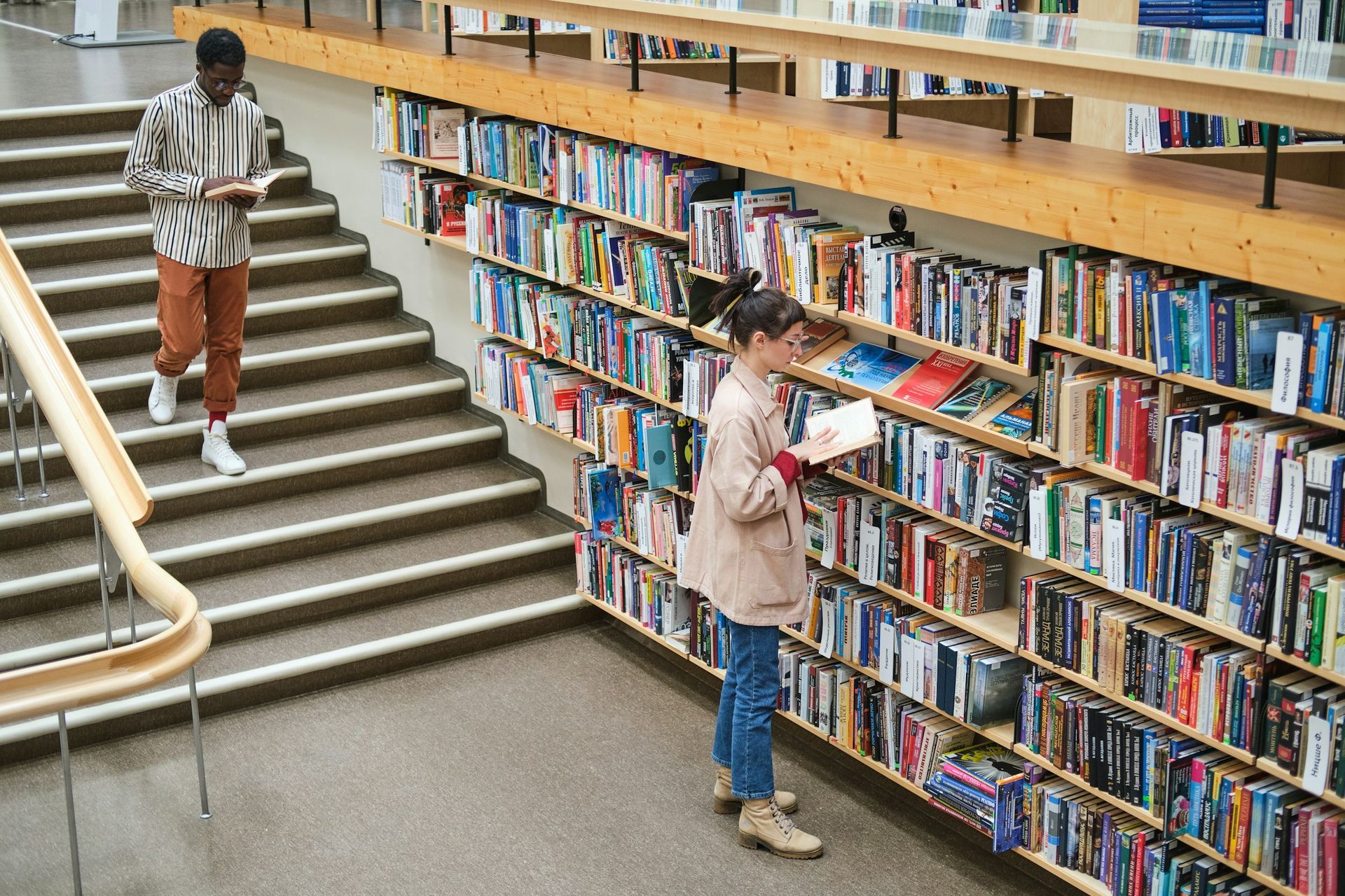 Students studying in a modern library filled with books – representing UniHouse's commitment to lear