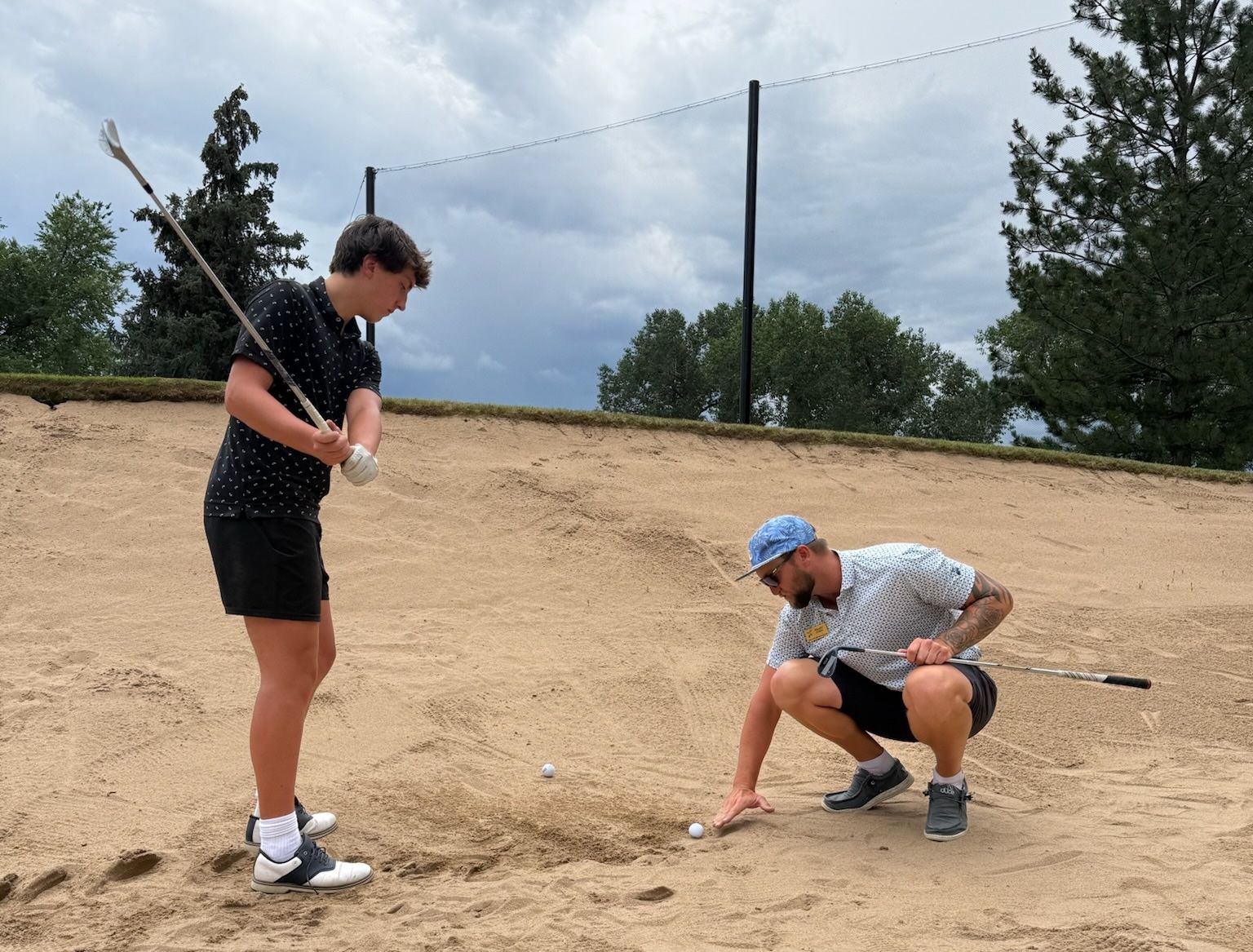 Jeramy Curry, PGA, in a lesson during Teach Fore REACH week.
