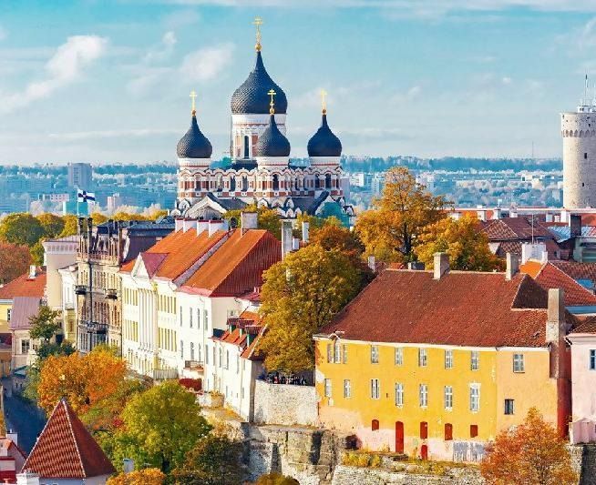 Colorful old town rooftops with St. Alexander Nevsky Cathedral under a bright blue sky