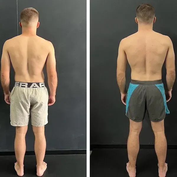 Back view comparison of a man wearing gray and black shorts against a plain dark wall