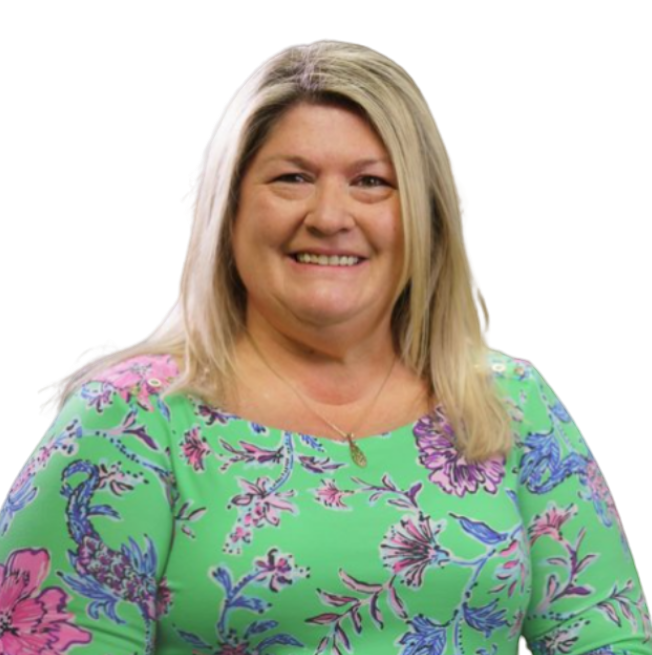 Lola Moore smiling in a green floral blouse against a white background
